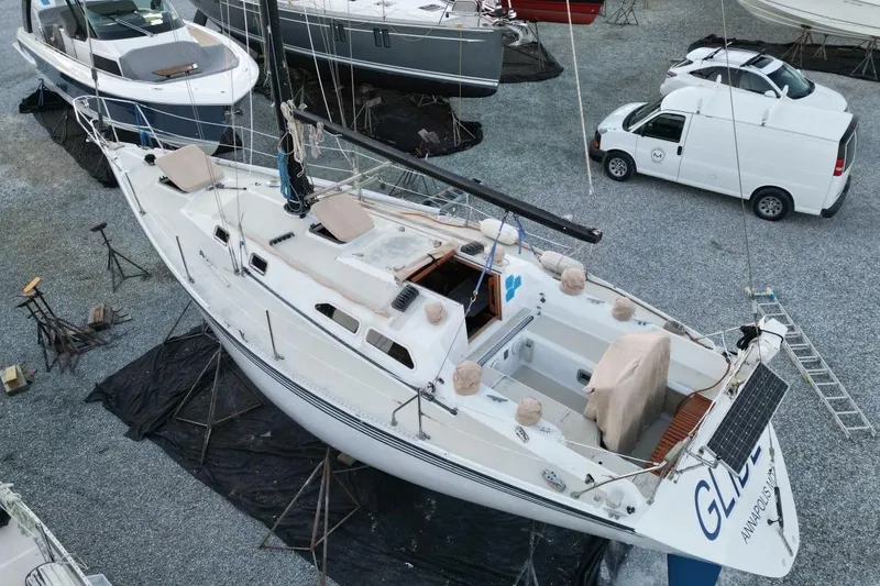 Slide: The Image of 1981 Ericson 36 sailboat on land, surrounded by other boats and vehicles. - 5