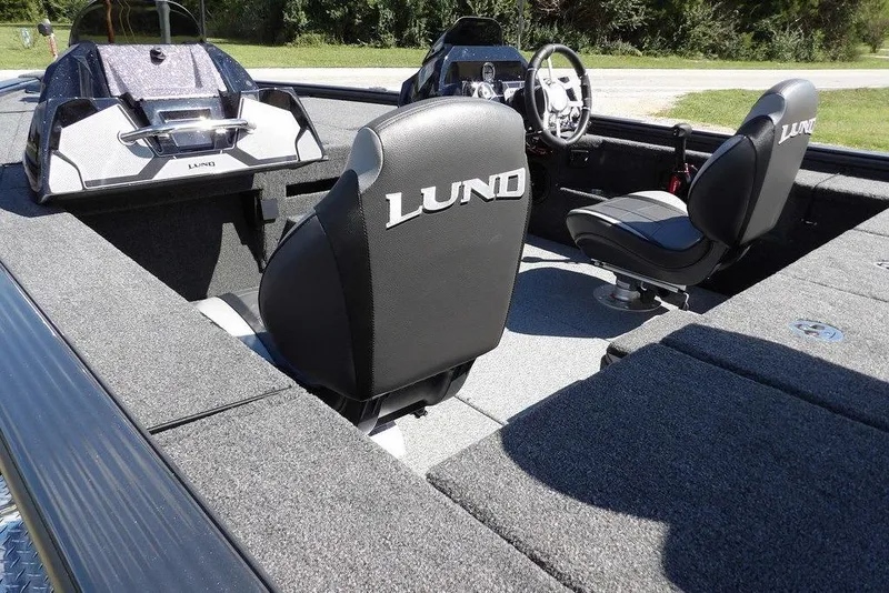 Slide: The Image of 2026 Lund 1875 Pro-V Bass XS boat interior with sleek seating and modern design. - 11