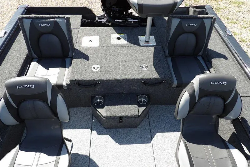 Slide: The Image of 2026 Lund 1875 Pro-V Bass XS boat interior with four cushioned seats and storage compartments. - 13