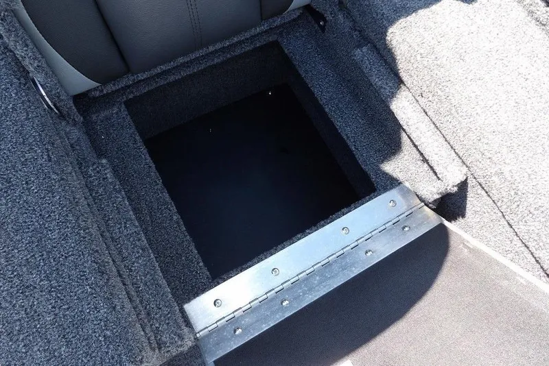 Slide: The Image of 2026 Lund 1875 Pro-V Bass XS storage compartment with carpeted interior and metal hinge. - 14
