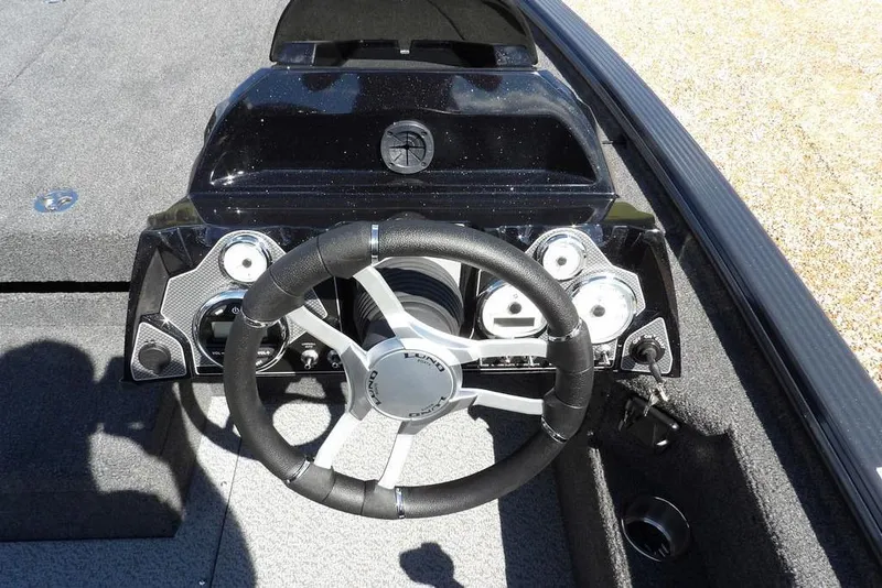 Slide: The Image of 2026 Lund 1875 Pro-V Bass XS boat dashboard with steering wheel and gauges. - 19