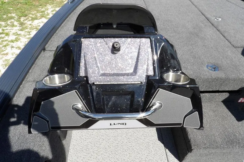 Slide: The Image of 2026 Lund 1875 Pro-V Bass XS boat interior with cup holders and storage compartment. - 26