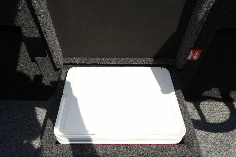Slide: The Image of 2026 Lund 1875 Pro-V Bass XS interior storage compartment with white lid. - 34