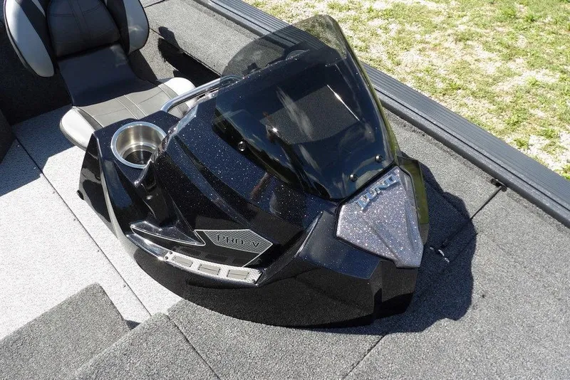 Slide: The Image of 2026 Lund 1875 Pro-V Bass XS boat console with sleek black design and cup holder. - 38