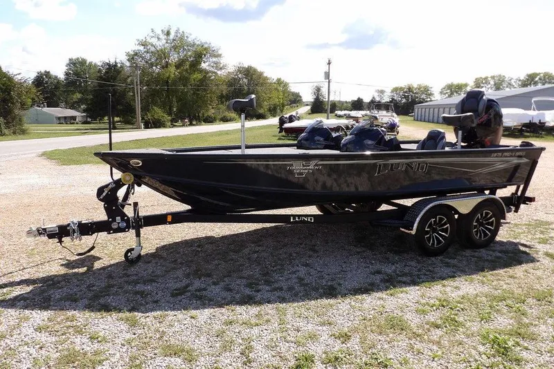 Slide: The Image of 2026 Lund 1875 Pro-V Bass XS boat on trailer, parked outdoors. - 5