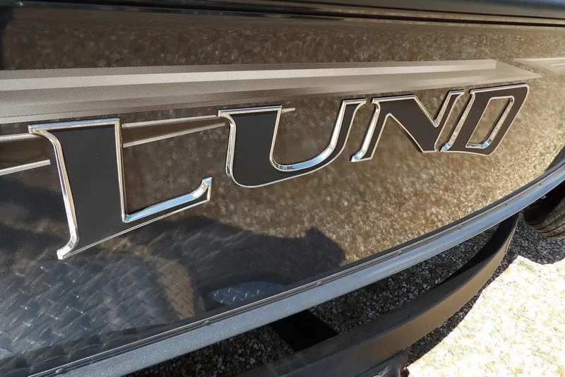 Slide: The Image of Close-up of 2026 Lund 1875 Pro-V Bass XS logo on boat exterior. - 50