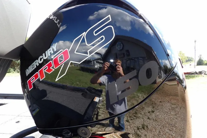 Slide: The Image of Mercury Pro XS 150 engine on 2026 Lund 1875 Pro-V Bass XS boat, reflecting surroundings. - 57