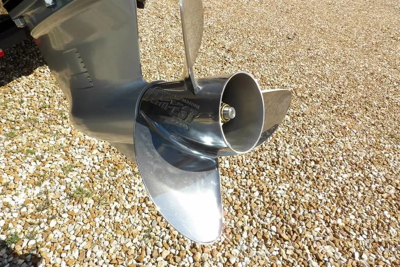 Slide: The Image of 2026 Lund 1875 Pro-V Bass XS boat propeller on gravel surface. - 58