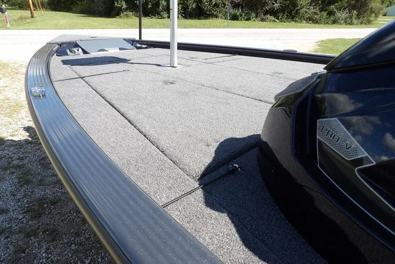 Slide: The Image of 2026 Lund 1875 Pro-V Bass XS boat deck with sleek design and durable carpeting. - 8
