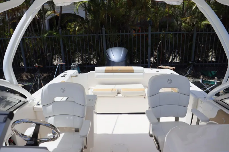 Slide: The Image of 2015 Everglades 245 CX boat interior with white seating and steering wheel. - 11