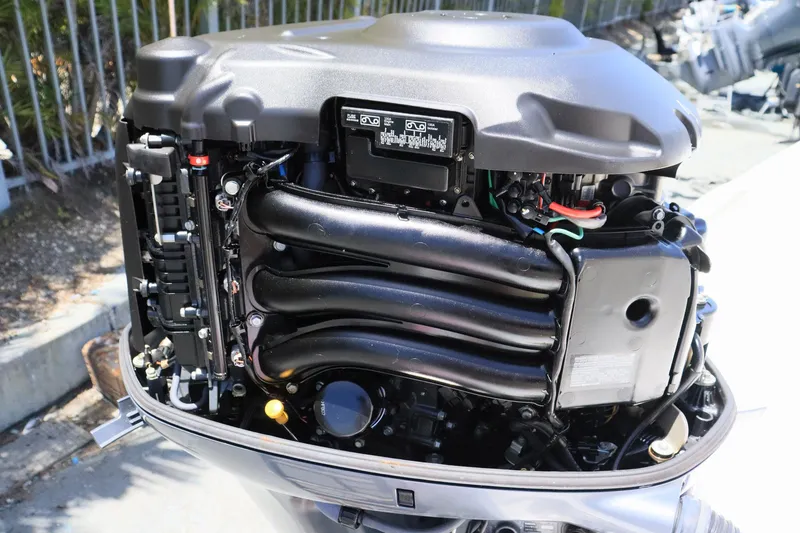Slide: The Image of Close-up of a 2015 Everglades 245 CX boat engine, showcasing intricate mechanical components. - 21