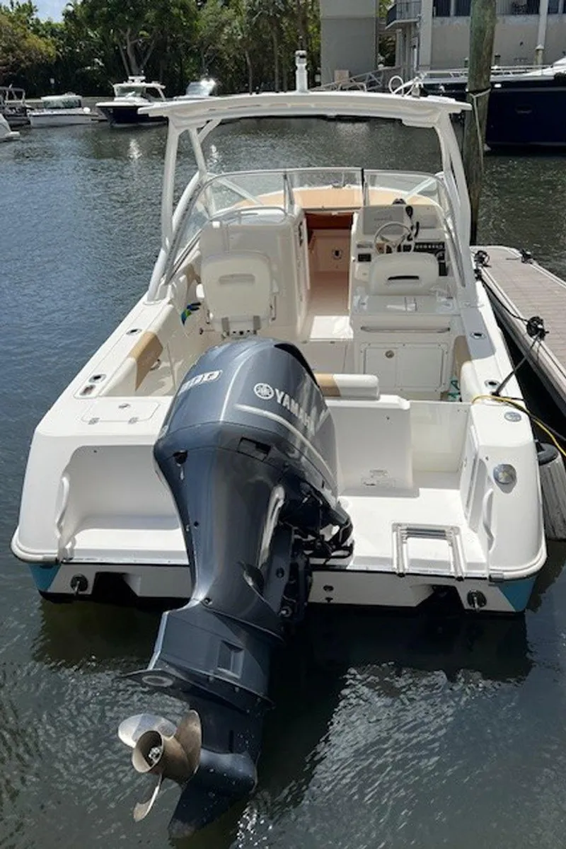 Slide: The Image of 2015 Everglades 245 CX boat with Yamaha engine docked in marina. - 6