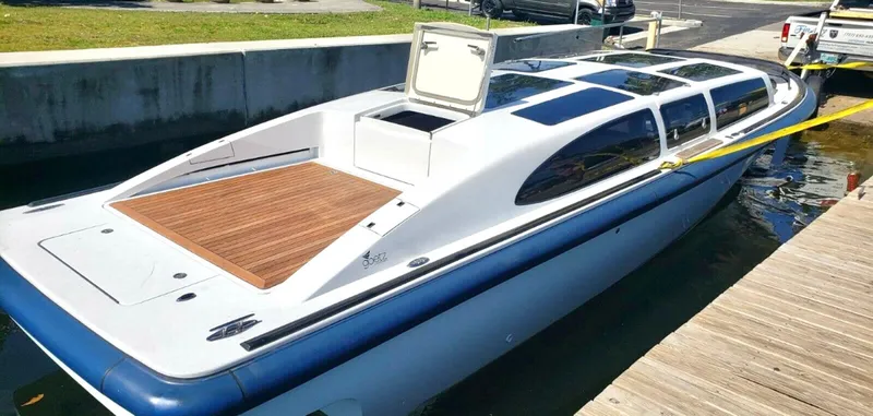 Slide: The Image of 2008 Goetz Custom Boats 33' Limo Tender docked, featuring sleek design and wooden deck. - 20