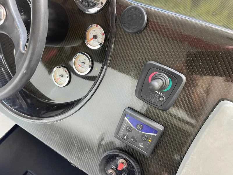Slide: The Image of Carbon fiber dashboard of 2008 Goetz Custom Boats 33' Limo Tender with gauges and controls. - 4