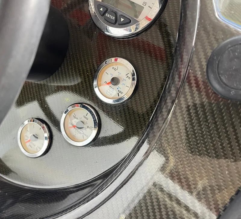 Slide: The Image of Carbon fiber dashboard with gauges on a 2008 Goetz Custom Boats 33' Limo Tender. - 5