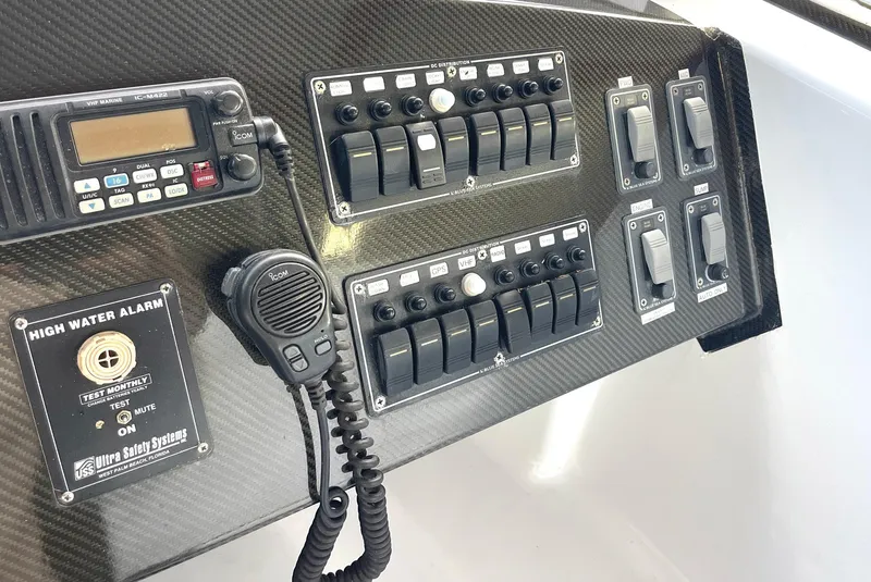 Slide: The Image of Control panel of a 2008 Goetz Custom Boats 33' Limo Tender with radio and switches. - 6