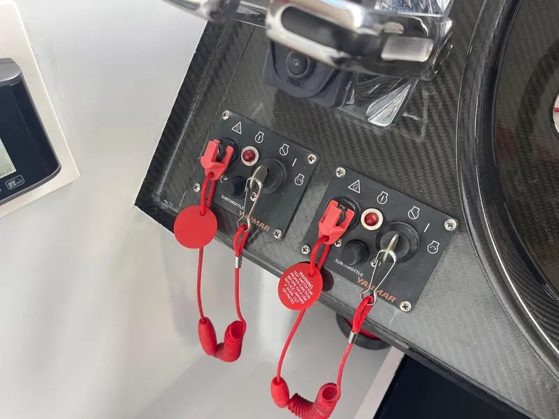 Slide: The Image of Control panel of a 2008 Goetz Custom Boats 33' Limo Tender with red safety lanyards. - 7