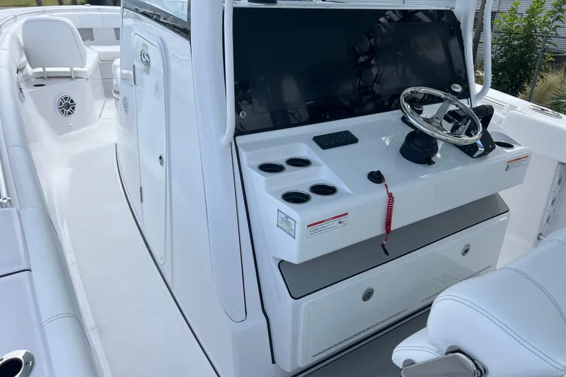 Slide: The Image of 2026 Sportsman Open 352 Center Console boat interior with steering wheel and seating. - 14