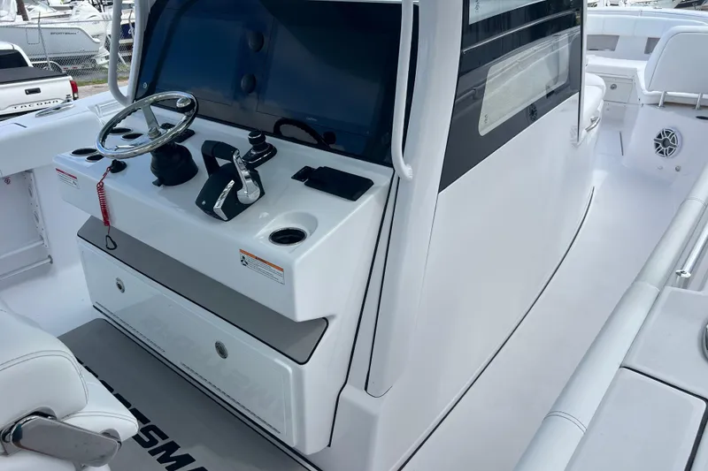 Slide: The Image of 2026 Sportsman Open 352 Center Console boat interior with steering wheel and controls. - 15