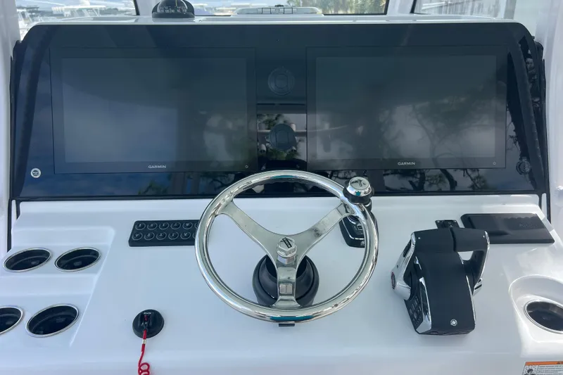 Slide: The Image of 2026 Sportsman Open 352 Center Console helm with dual Garmin displays and steering wheel. - 19
