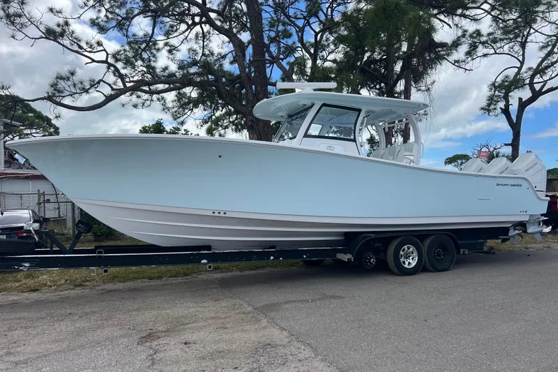 Slide: The Image of 2026 Sportsman Open 352 Center Console boat on trailer, parked outdoors. - 2