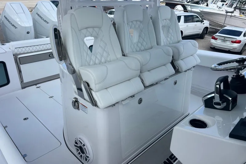 Slide: The Image of 2026 Sportsman Open 352 Center Console with luxurious white seating and modern controls. - 24