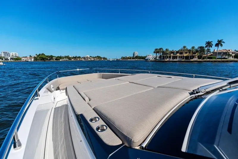 Slide: The Image of 2024 Azimut Verve 42 yacht with sunbed, cruising on a sunny day near luxury waterfront homes. - 34