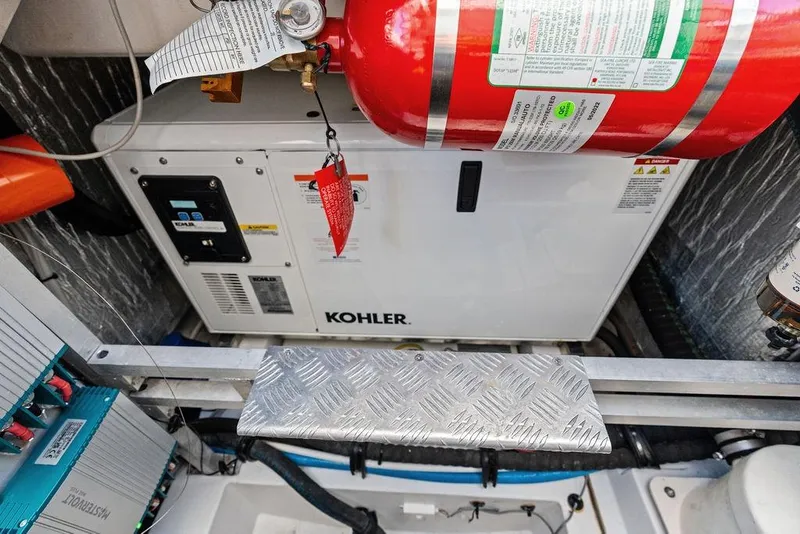 Slide: The Image of Engine room of 2024 Azimut Verve 42 with Kohler generator and fire extinguisher. - 49