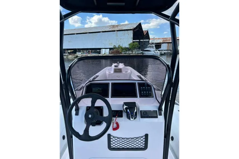 Slide: The Image of 2026 Ranieri CAYMAN 23 Sport boat cockpit with steering wheel and control panel. - 12