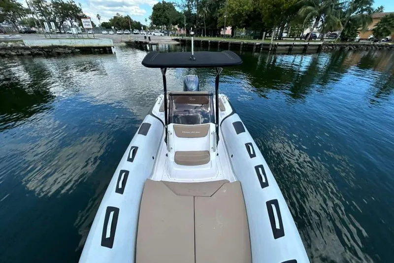Slide: The Image of 2026 Ranieri CAYMAN 23 Sport boat docked on calm water, featuring sleek design. - 13