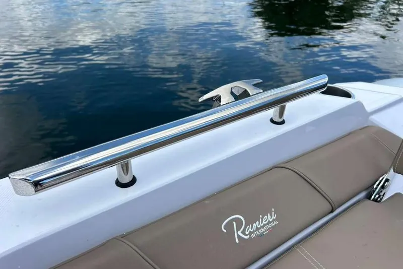 Slide: The Image of 2026 Ranieri CAYMAN 23 Sport boat with sleek chrome railing and logo detail. - 17