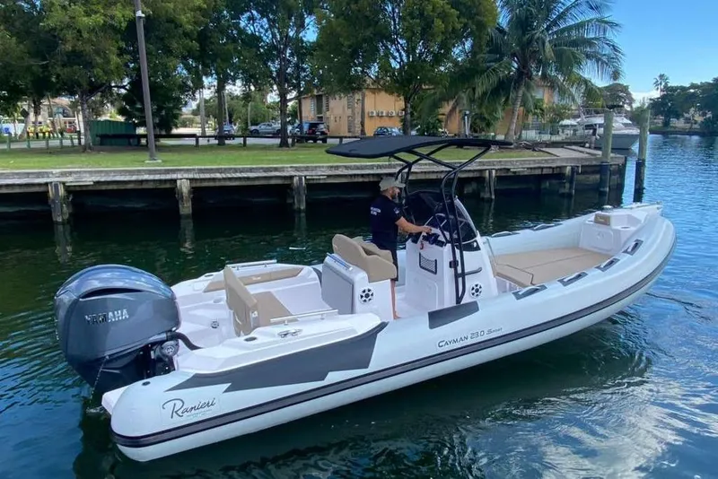 Slide: The Image of 2026 Ranieri CAYMAN 23 Sport boat on water, featuring sleek design and Yamaha engine. - 2