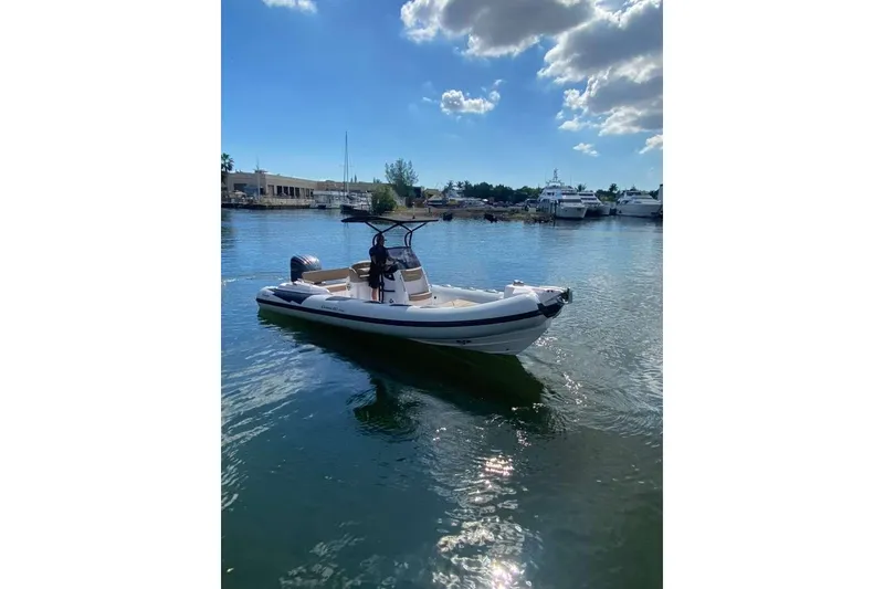 Slide: The Image of 2026 Ranieri CAYMAN 23 Sport boat on calm water under a blue sky. - 6