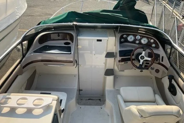 Slide: The Image of 2001 Regal 2550 LSC boat interior with steering wheel and dashboard controls. - 3