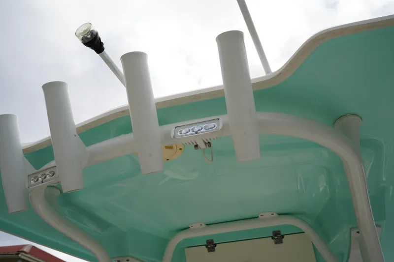 Slide: The Image of 2023 Robalo R222 Center Console boat's rod holders and T-top detail. - 11