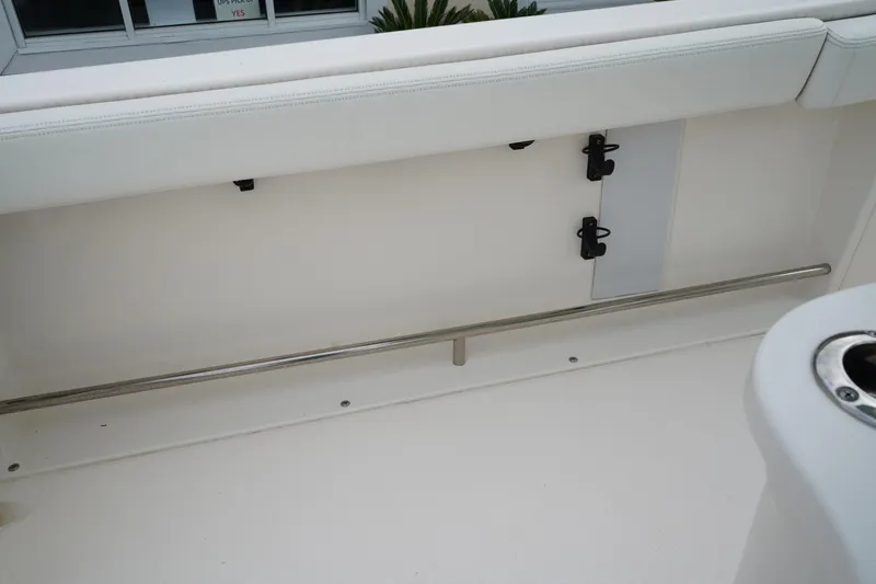 Slide: The Image of 2023 Robalo R222 Center Console interior with stainless steel rail and cushioned seating. - 14