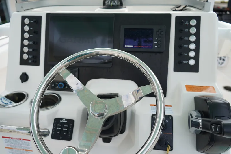 Slide: The Image of 2023 Robalo R222 Center Console dashboard with steering wheel and navigation controls. - 17
