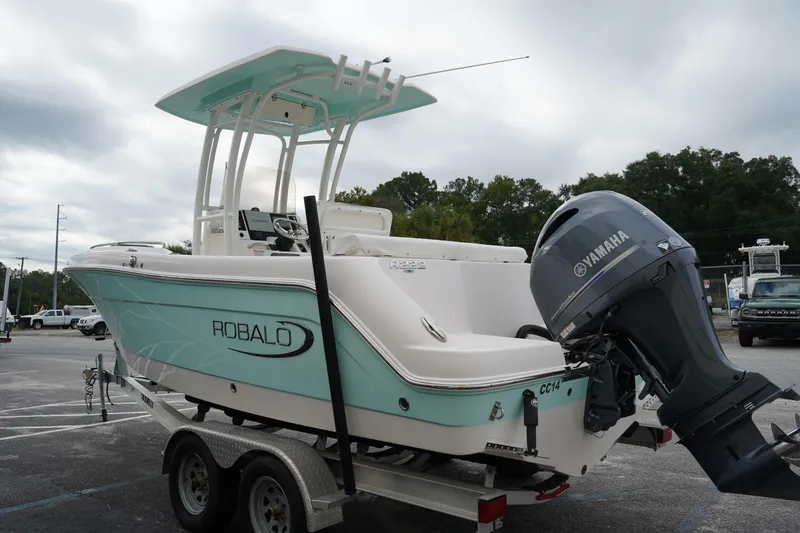 Slide: The Image of 2023 Robalo R222 Center Console boat with Yamaha engine on trailer. - 2