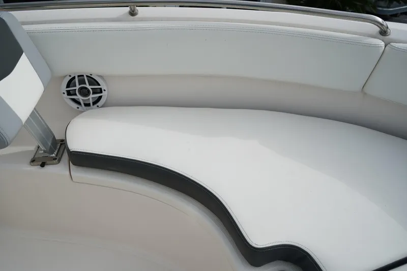 Slide: The Image of 2023 Robalo R222 Center Console boat interior with cushioned seating and speaker. - 22