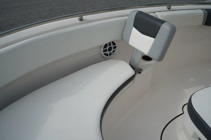 Slide: The Image of 2023 Robalo R222 Center Console boat interior with cushioned seating and speaker. - 24