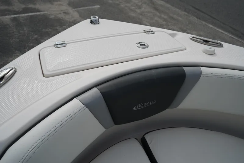 Slide: The Image of 2023 Robalo R222 Center Console boat bow seating and storage compartment. - 26