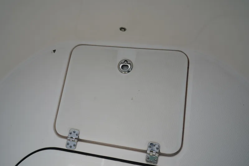 Slide: The Image of 2023 Robalo R222 Center Console boat hatch with metal latch and hinges. - 27
