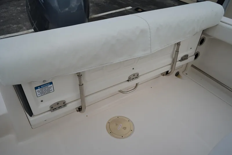 Slide: The Image of 2023 Robalo R222 Center Console boat interior with cushioned seating and storage. - 6