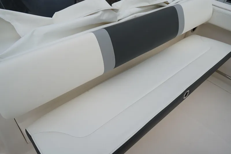 Slide: The Image of 2023 Robalo R222 Center Console boat seat with white and gray upholstery. - 7