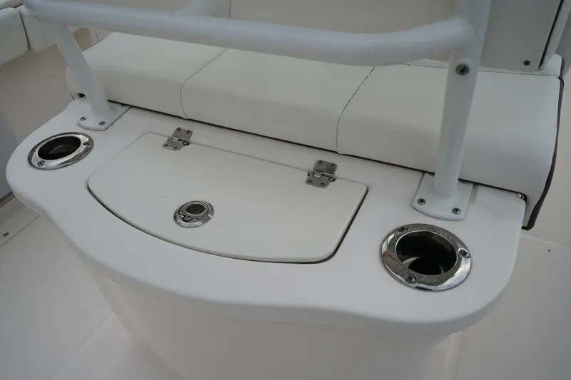Slide: The Image of 2023 Robalo R222 Center Console boat seating with cup holders and storage compartment. - 8