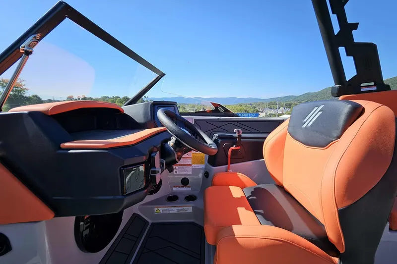 Slide: The Image of 2026 ATX Surf Boats 22 Type-S interior with orange seating and steering wheel. - 10