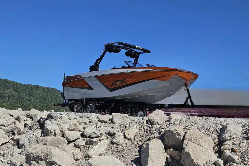 Slide: The Image of 2026 ATX Surf Boats 22 Type-S on rocky terrain under clear blue sky. - 13