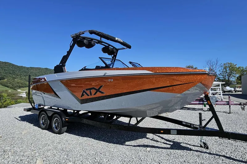 Slide: The Image of 2026 ATX Surf Boats 22 Type-S on trailer, orange and white design, outdoors. - 19