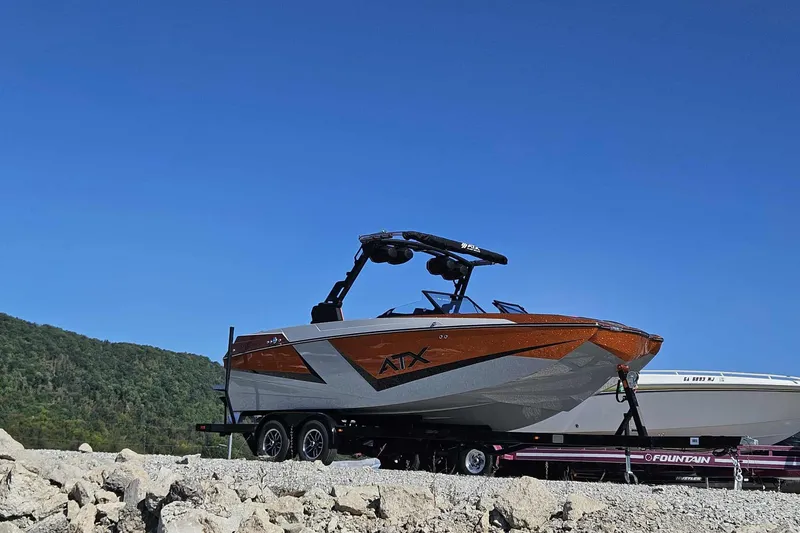 Slide: The Image of 2026 ATX Surf Boats 22 Type-S on trailer, set against a clear blue sky. - 20