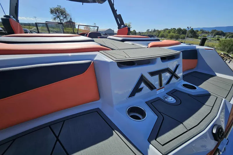 Slide: The Image of 2026 ATX Surf Boats 22 Type-S rear view with orange and black seating. - 23